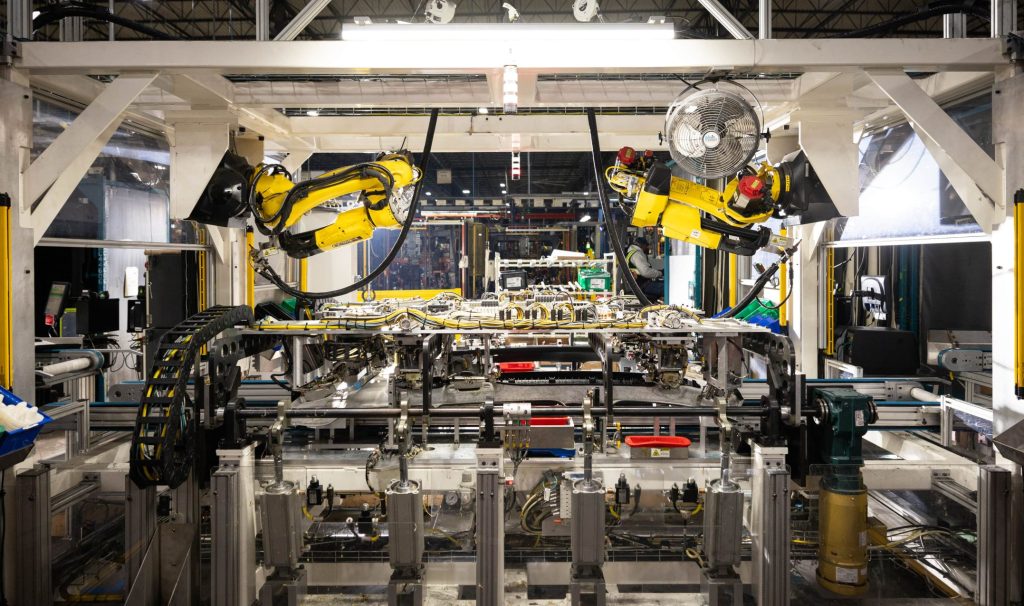 Looking down an assembly line with robotic arms