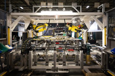 Looking down an assembly line with robotic arms