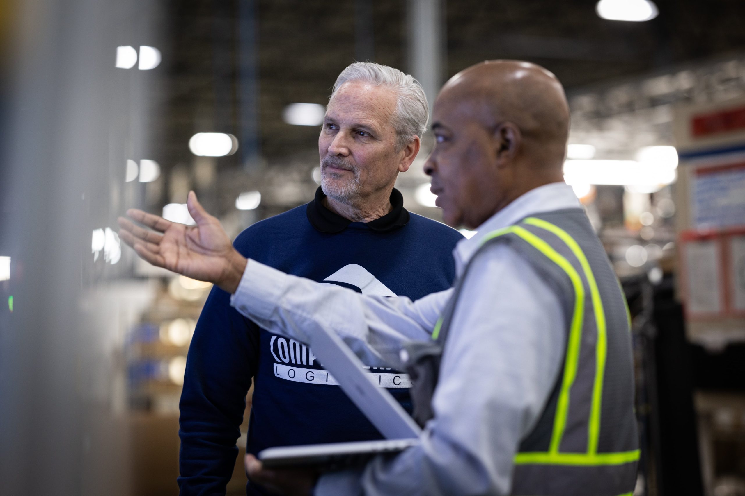 Two men reviewing plans for a warehouse