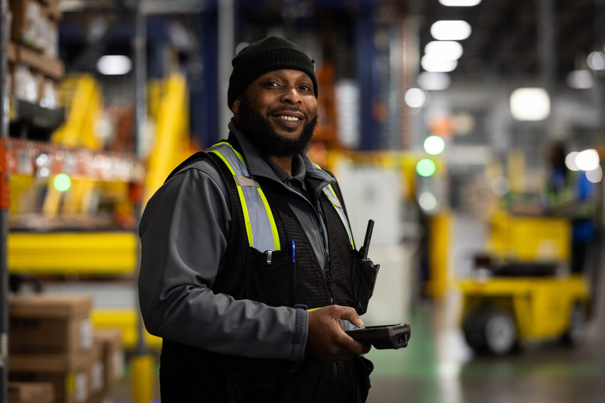 A smiling CLI employee using a scan gun