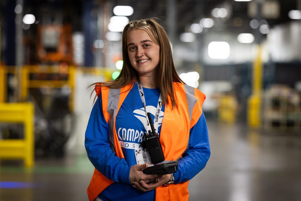 A smiling CLI employee holding a scan gun